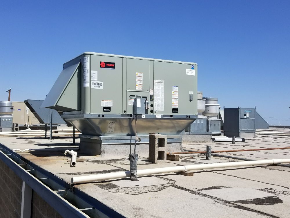 Rooftop HVAC unit positioned on a flat commercial roof in Waltham, MA.